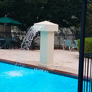 Relax by the fountain at French Quarter Resort
